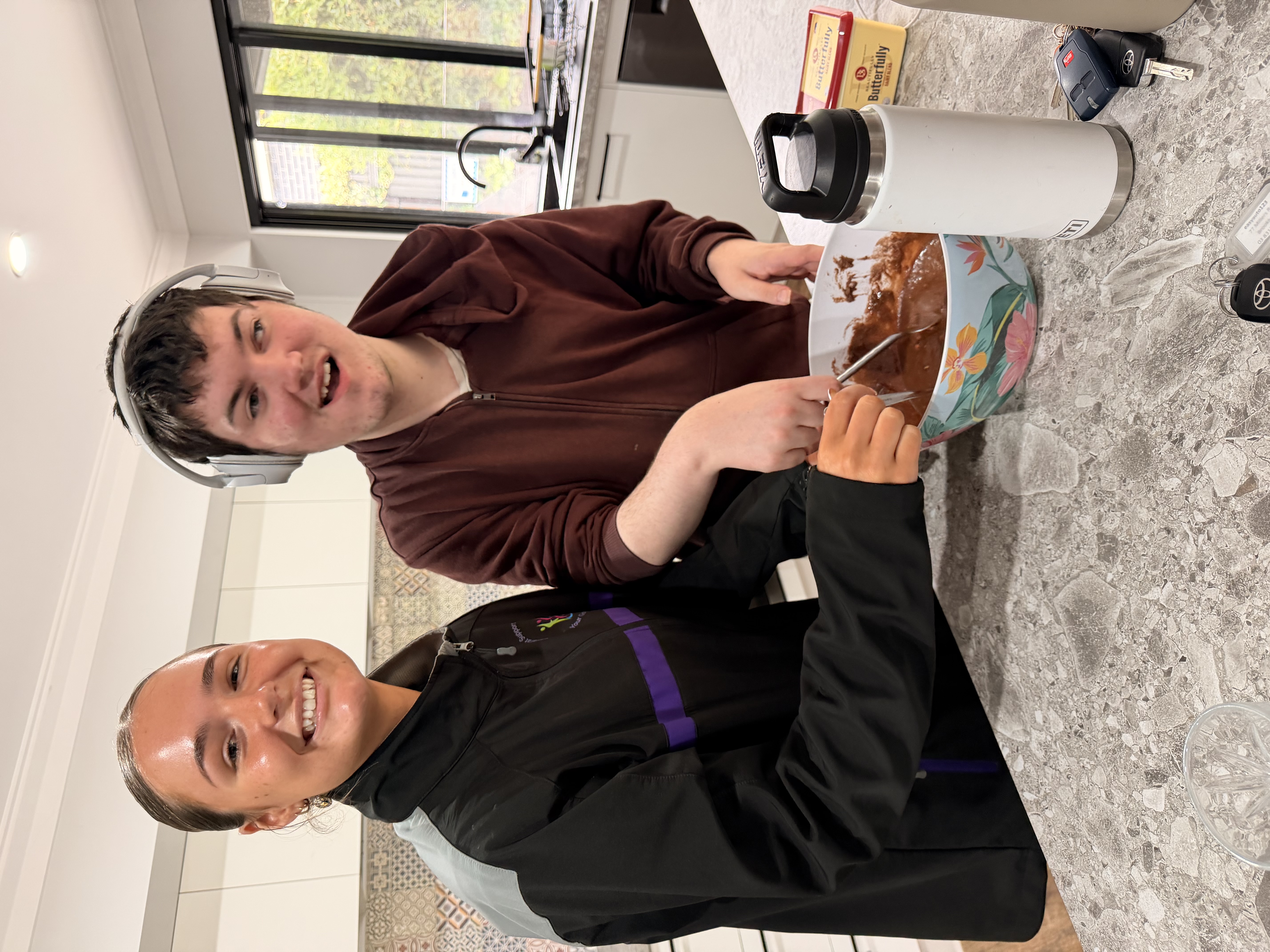 Participant and staff cooking together